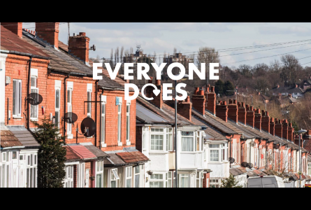 Terrace of houses with text "EVERYONE DOES" in white lettering